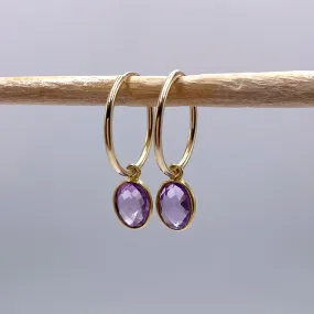 Gemstone earrings with amethyst (purple) oval crystal drops on gold small hoops